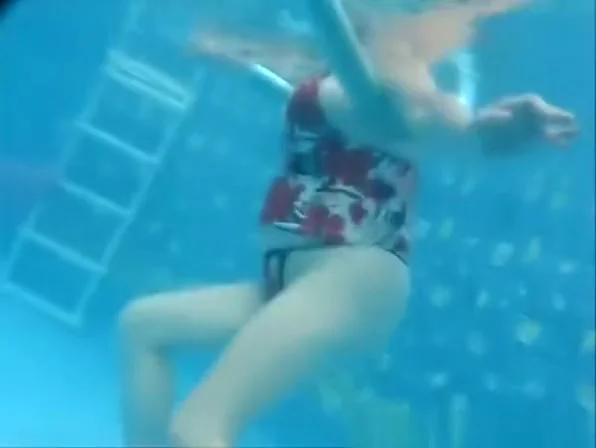Busty mature woman filmed under water