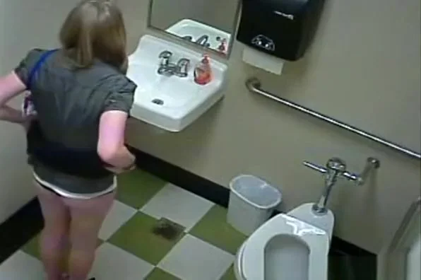 Blonde peeing in public toilet