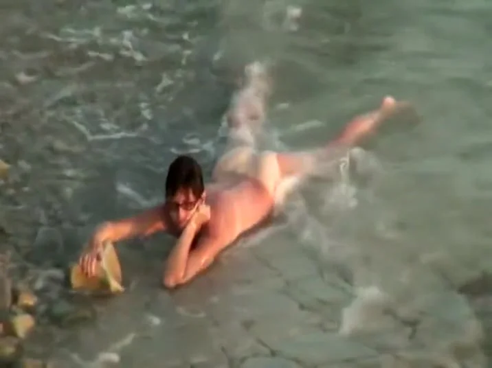 Sunburned woman is naked on a beach