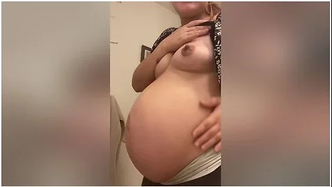Pregnant Milf Rubs Belly And Then Strips