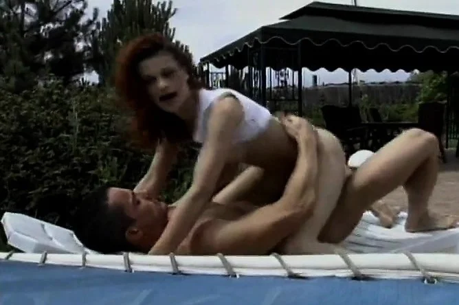 Sexy slender redhead with lovely boobs impales herself on a long pole
