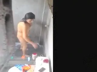 Woman filmed in secret while bathing in a outdoor scene