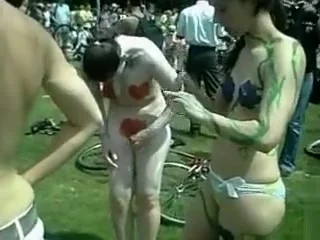 Naturist girls and guys have their completely naked bodies painted