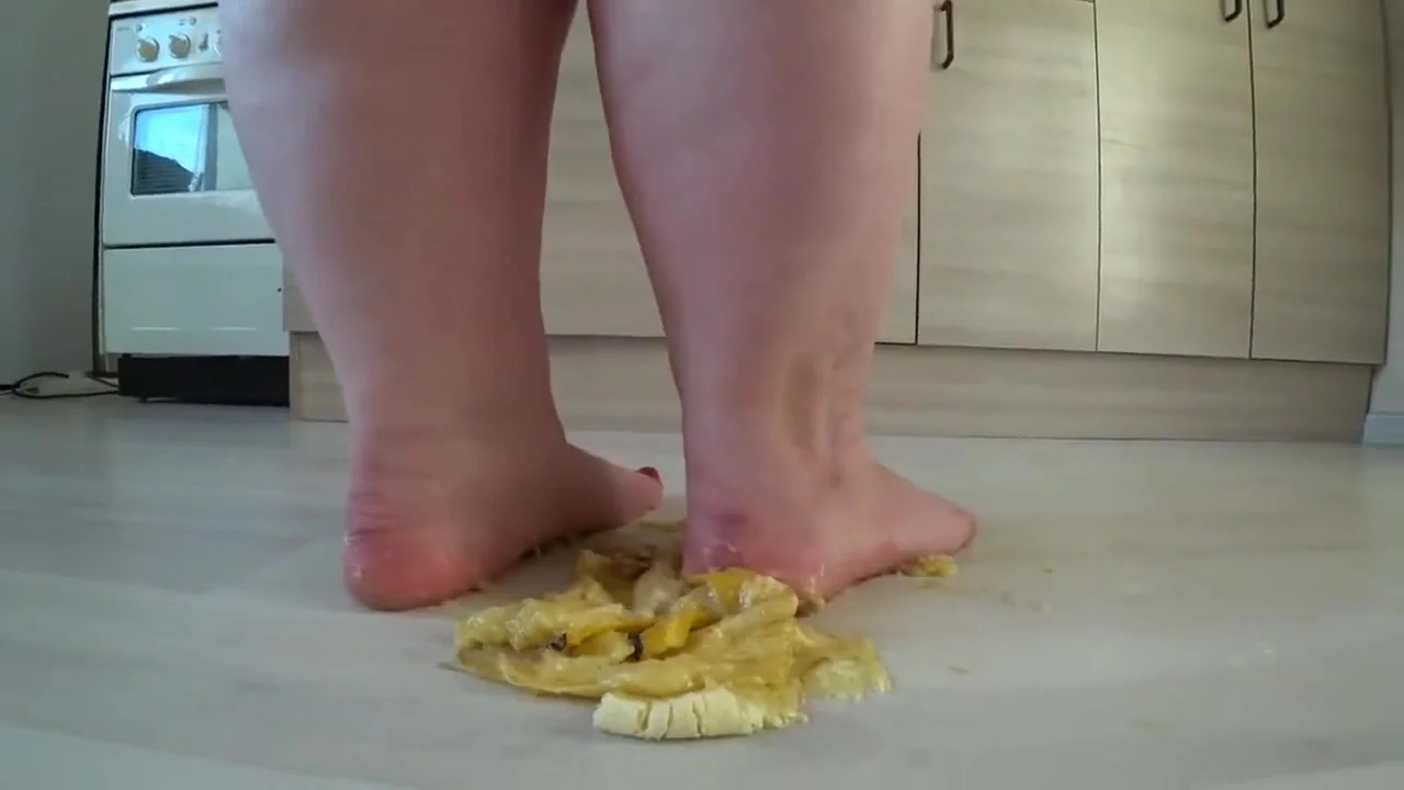 a big mature woman, bbw, smash a banana with bare feet, heels. crash trampl