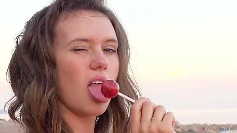Kinky Lucy Dances Naked In The Beach And Masturbates With A With Lolli Pop