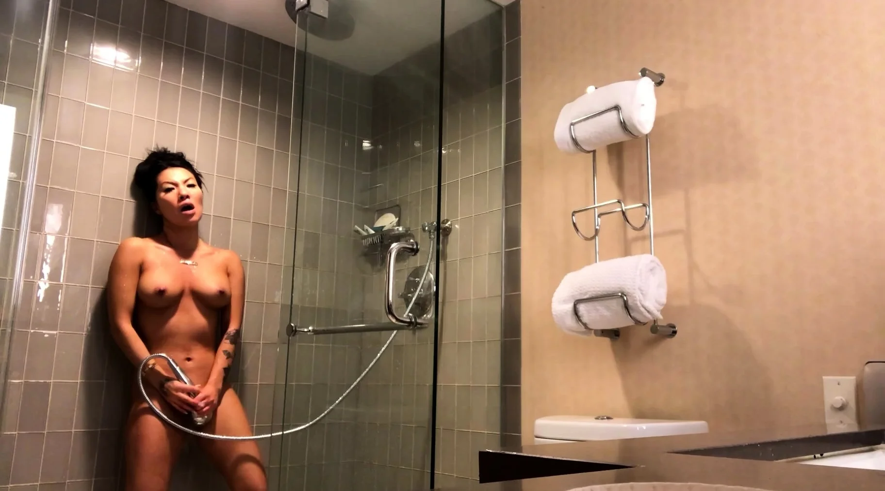Sexy amateur chick taking a shower and masturbating