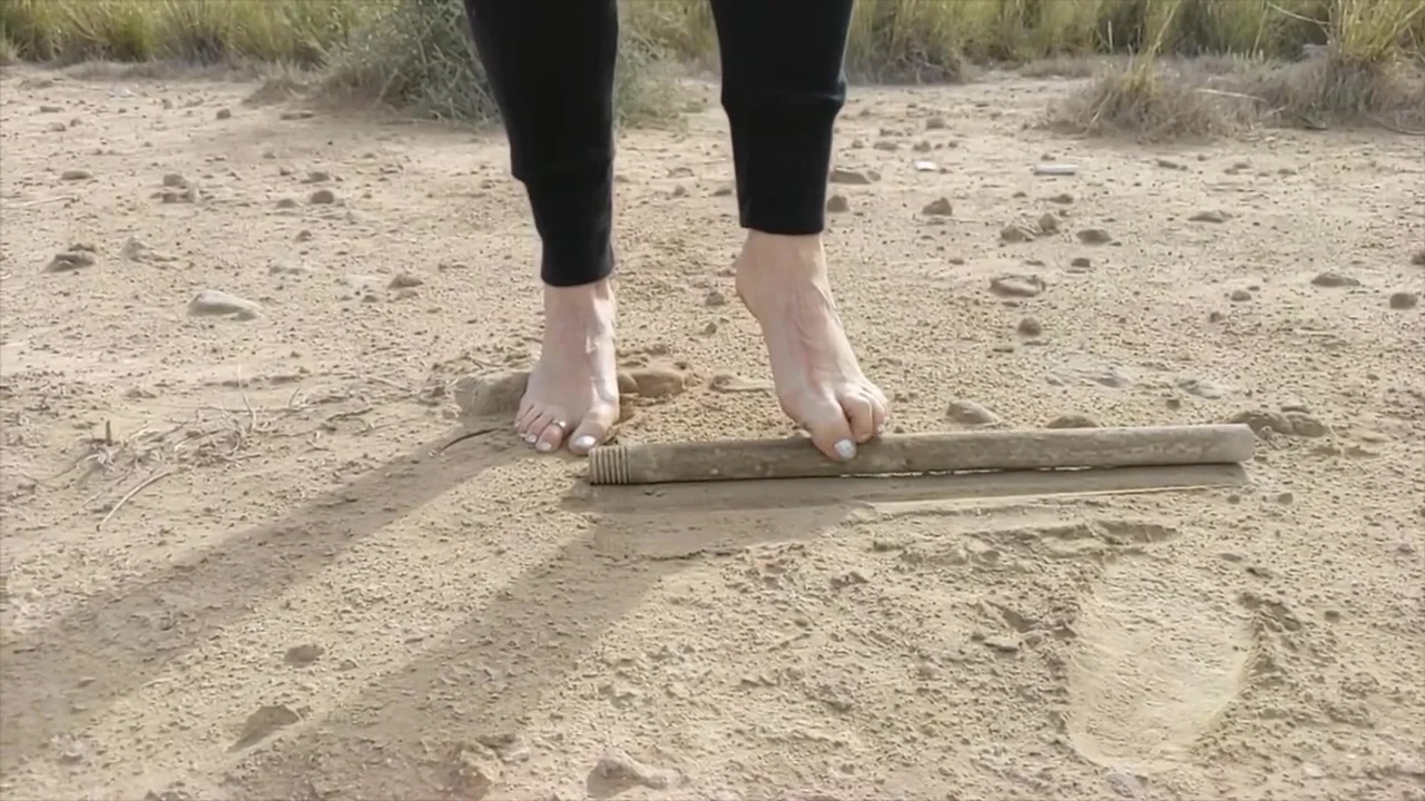 Super slow motion feet walking on dusty ground -- DIRTY FEET