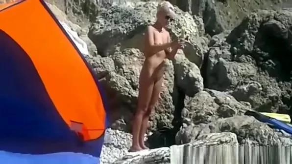 Blonde nudist woman secretly filmed at beach