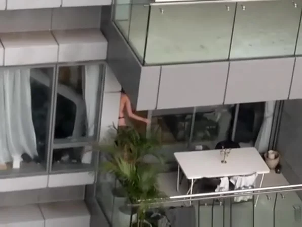 Neighbor spied topless in balcony