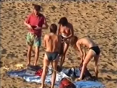 Nudist family leaving the beach