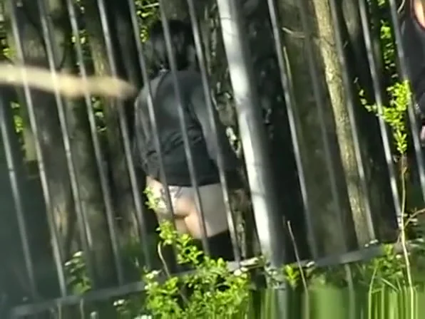Woman pissing in public park