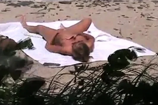 voyeur catches MILF on a beach