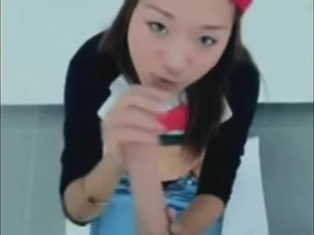 Cute Chinese babe enjoys sucking a huge pole