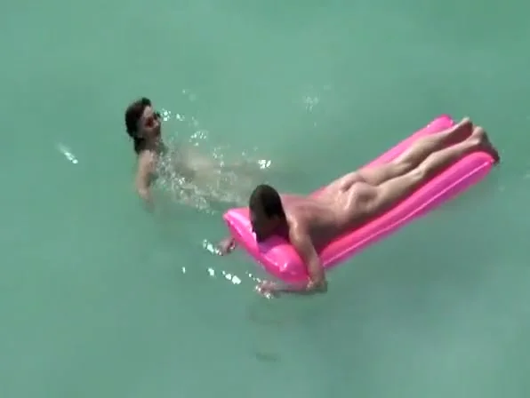 Small boobs nudist swimming in the water