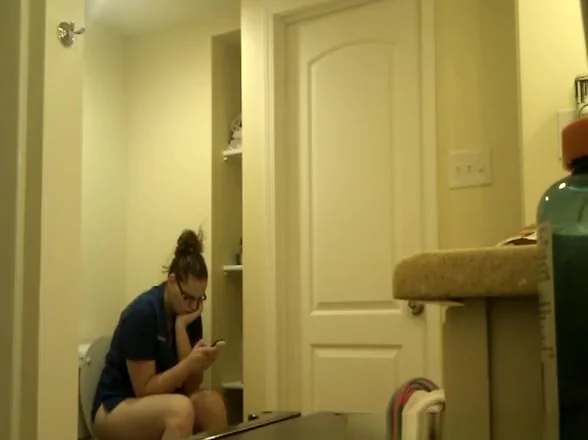 Chubby nerd girl in toilet
