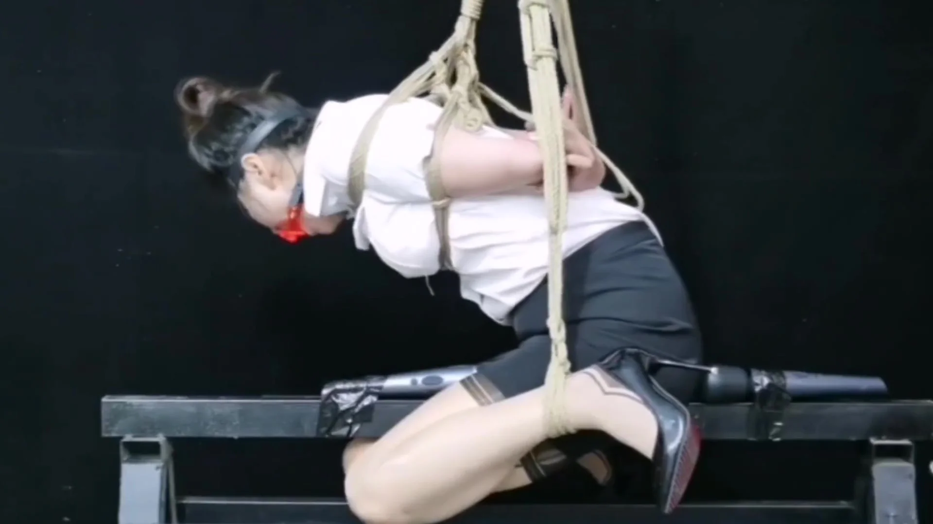 Chinese Model Sitting On A Iron Bar