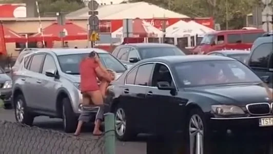 Boy with girl having sex on a car in the bazaar.