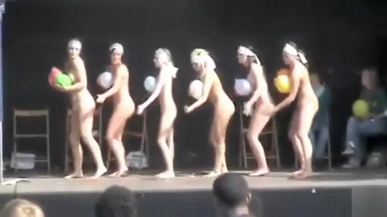 Naked ladies dance on stage with balloons