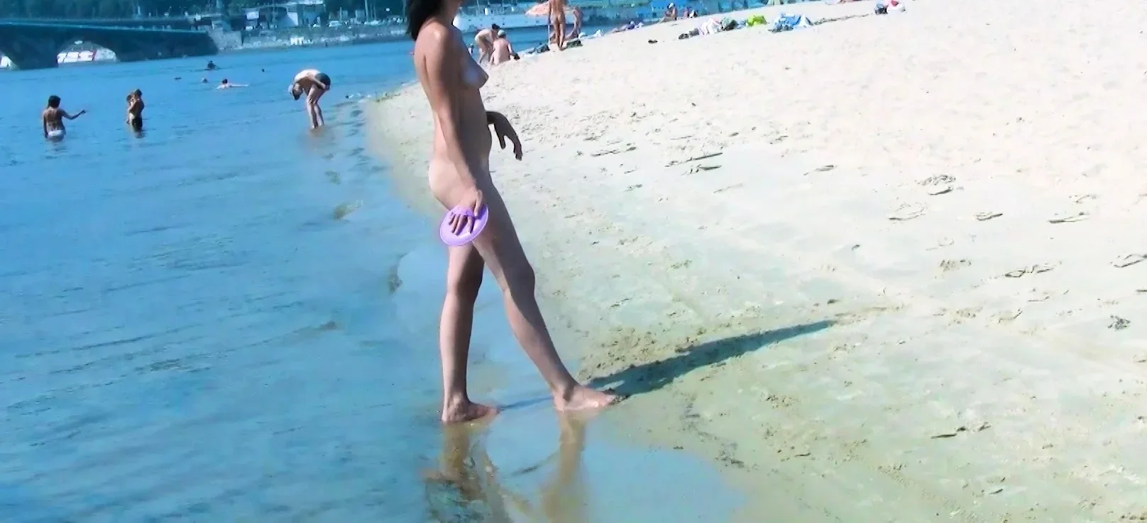 Hot nudist teen filmed by voyeur as she sits naked outside