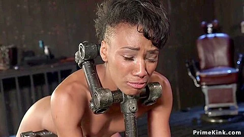 Slim ebony whipped in device bondage