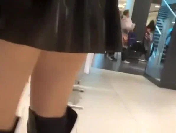 Exhibitionist wife in short latex skirt bending over