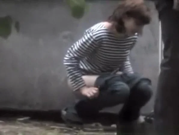 Woman caught peeing in the back of old place