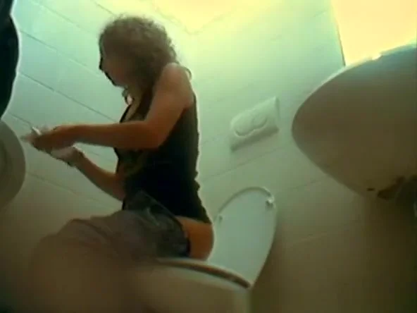 Woman in glasses and jeans pants spied pissing