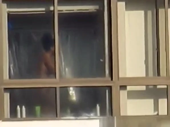 Ebony spied through her apartment window