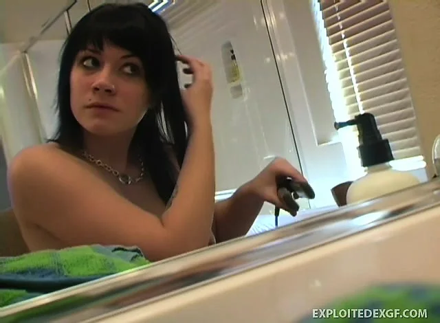 Brunette Andi is styling her hair ready to go out while in the nude