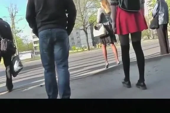 Girl in red short skirt and black leggings upskirted
