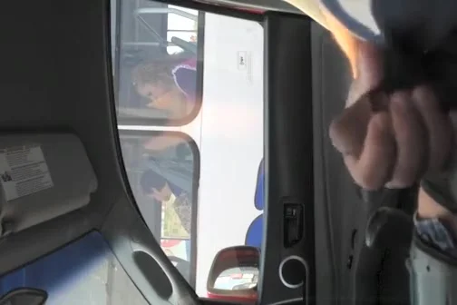 Guy strokes his cock in traffic next to woman in bus