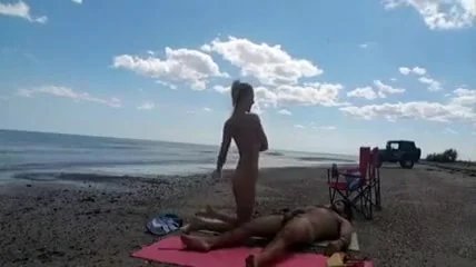 Nudist wife jerks off strangers at the beach and they cum on her