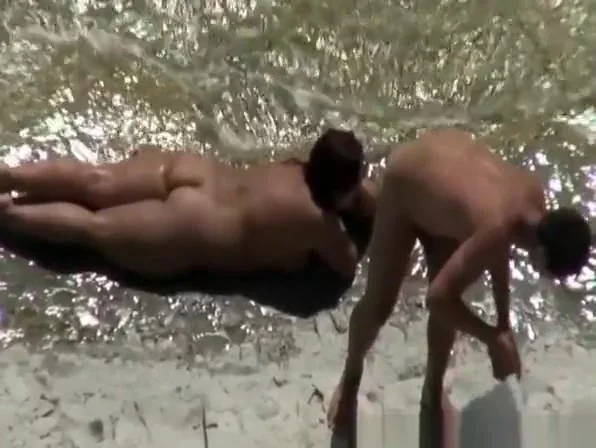 Chubby nudist woman sunbathing and swimming