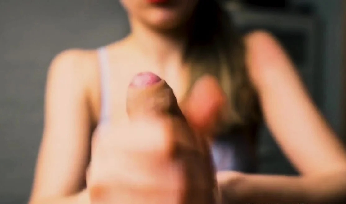Red-lipped beauty gives an intense handjob to her man