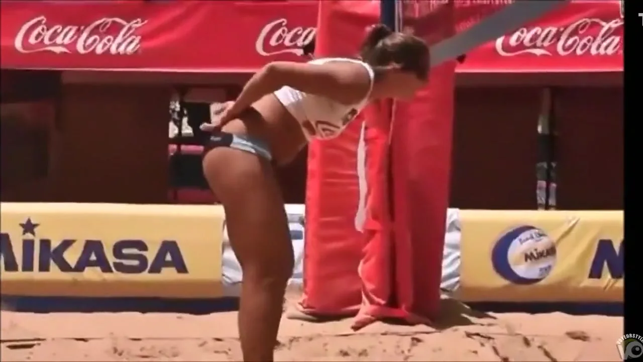 Beach volleyball girls with athletic asses in bikini bottoms