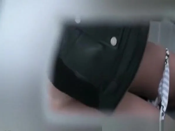 Woman peeing in portable public toilet