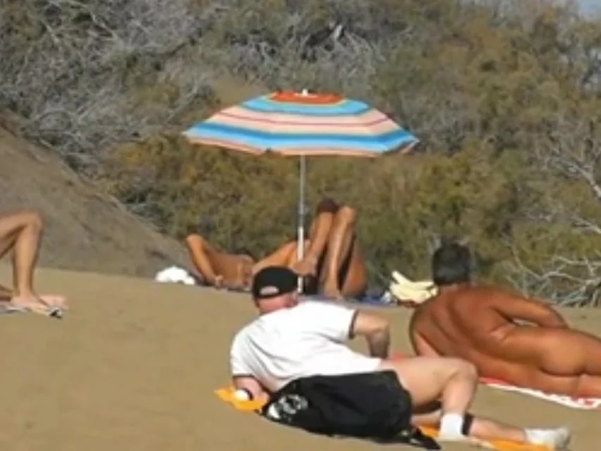 Daring masturbation on a crowdy beach