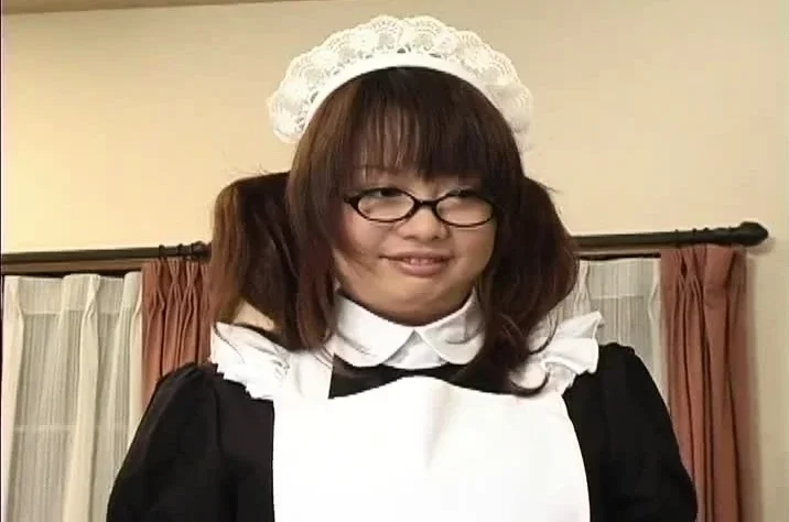 Japanese maid in uniform licking and humming a stiff baton