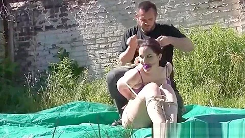 Outdoor bondage of American fetishist Caroline Pierce tied