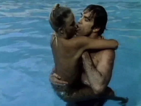 Busty brunette is in the pool naked and they go in for some passionate sex