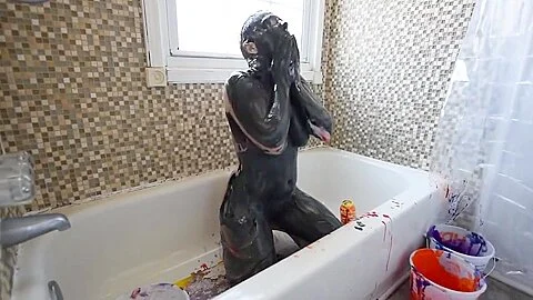 Girl in multicolored paint masturbates