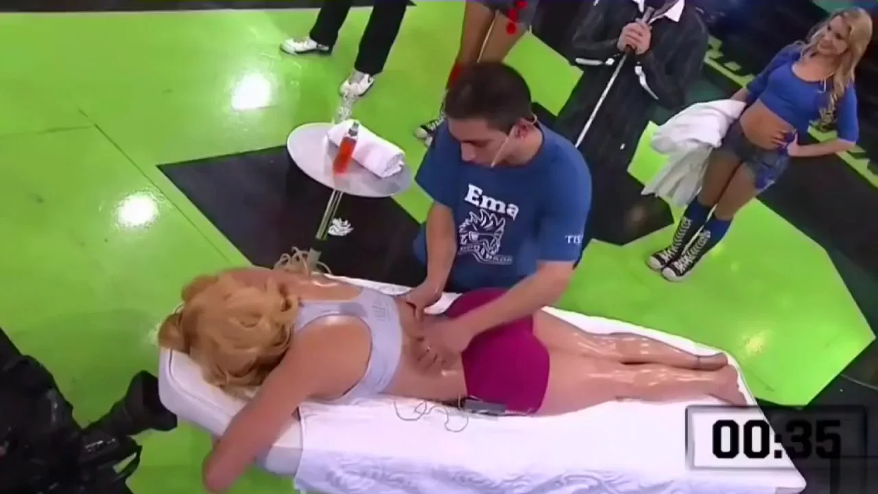 Athletic lady receives a massage live on the television