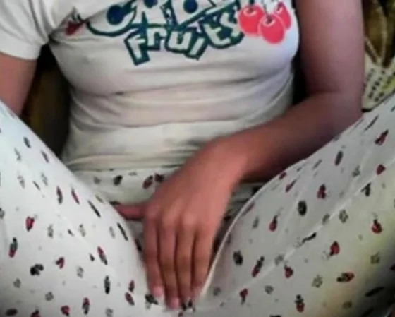 Amateur girl rubs her pussy through pajamas