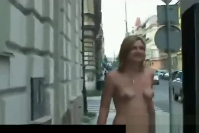 cute embarrassed girl walks naked through busy city streets
