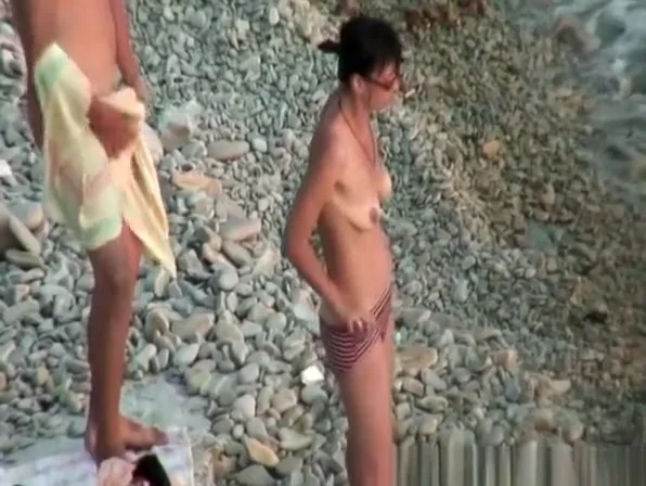 Hairy pussy nudist with glasses in the water