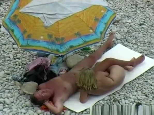 Nude couple enjoying beach day