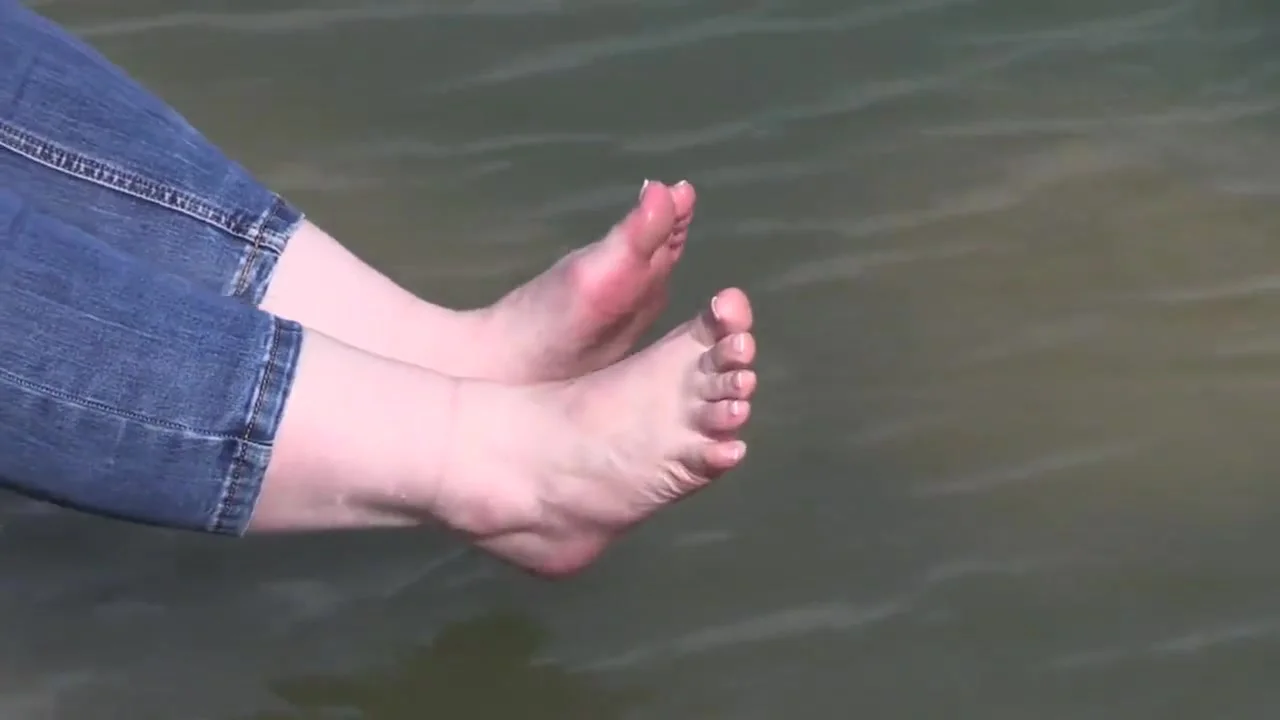 the feet of a mature lady on stones