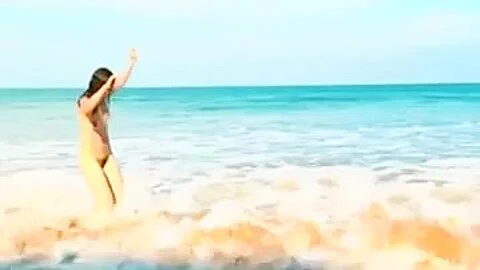 Horny brunette babe flashing a hairy pussy on the beach