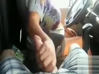 Wife gives big cock a handjob in the car