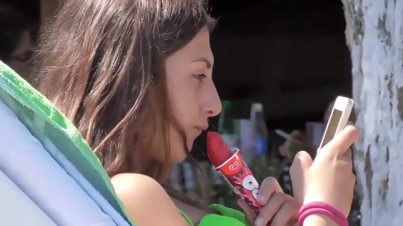 teen 18+ girl sucks on an ice cone